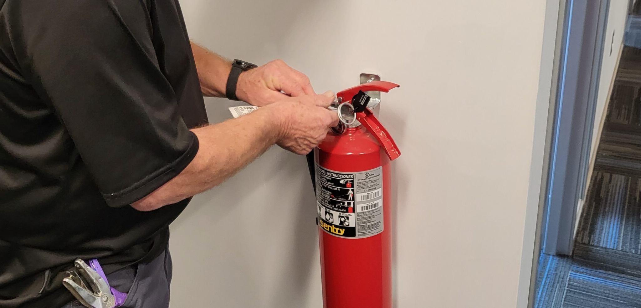 Technician servicing a fire extinguisher